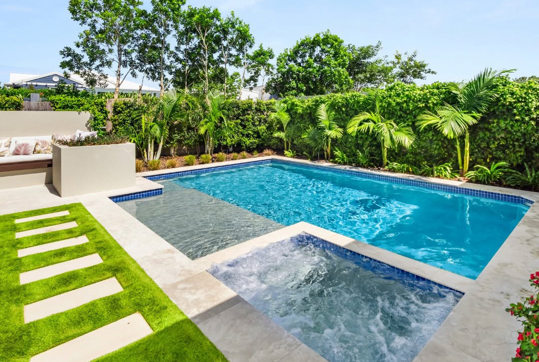 Geometric concrete pool with spa, splash deck and landscaping